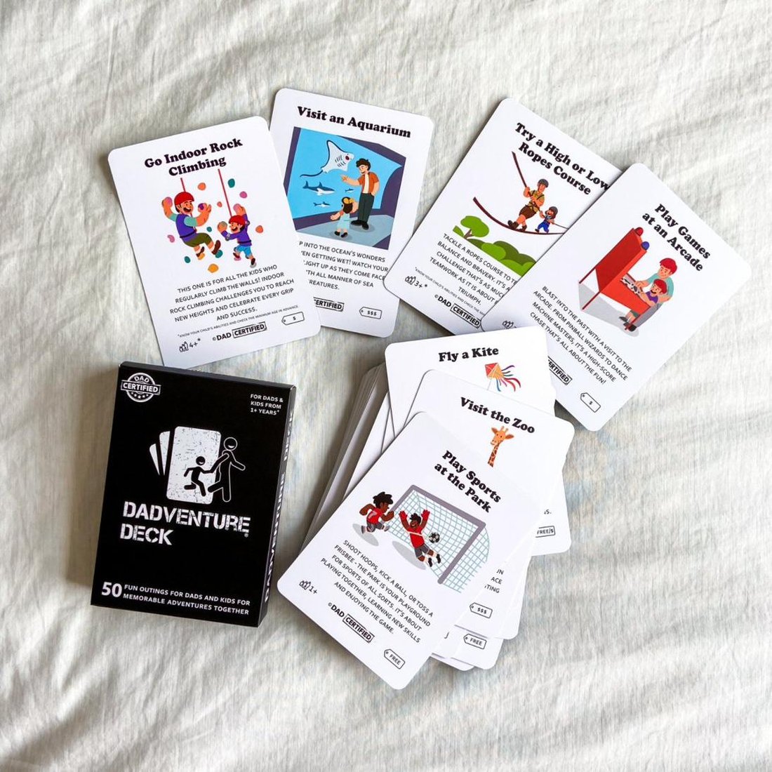 The Dadventure Deck cards fanned out showing illustrations and age and cost icons